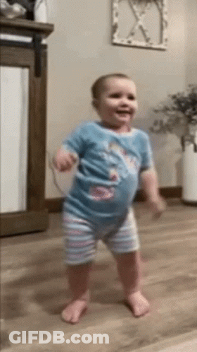 Baby Standing On Wooden Floor GIF