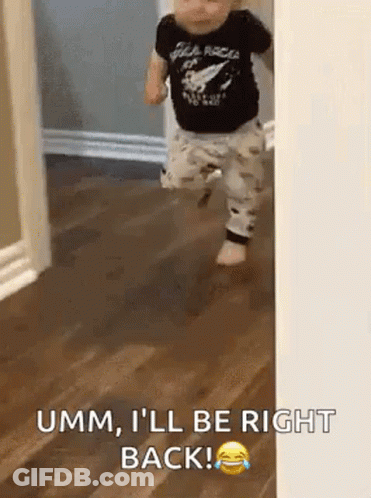 Baby Walking On Wooden Floor In Black Shirt GIF