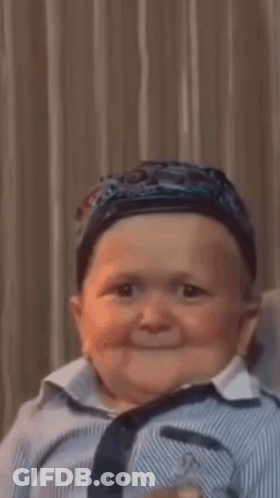 Baby Wearing Hat And Striped Shirt Smiling GIF