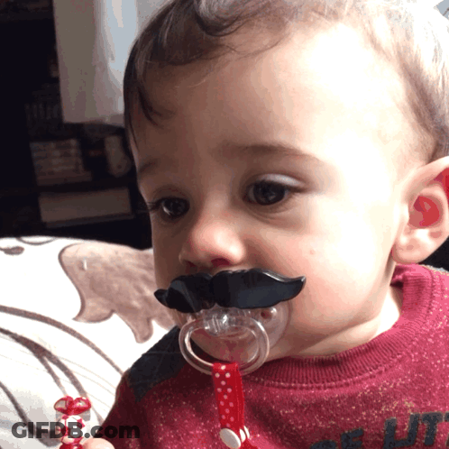 Baby Wearing Pacifier With Fake Mustache GIF