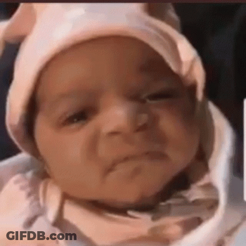 Baby Wearing Pink Hat Making Funny Face GIF