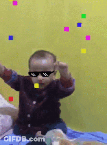 Baby Wearing Sunglasses On Bed In Front Of Yellow Wall GIF