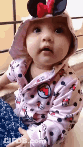 Baby With Bracelet Covering Face GIF