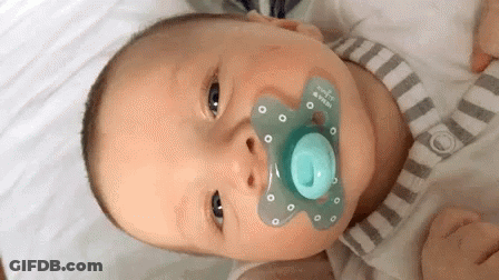 Baby With Pacifier Looking At Camera GIF