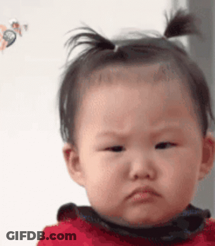 Baby With Ponytail Making Funny Face GIF