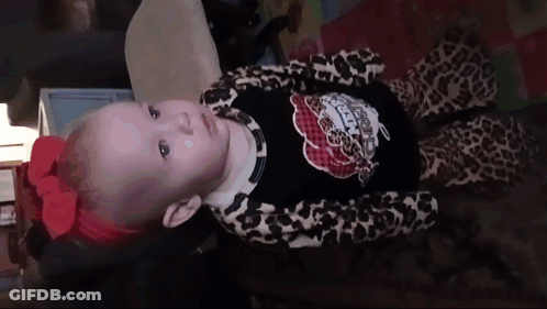 Baby With Red Bow And Leopard Outfit GIF