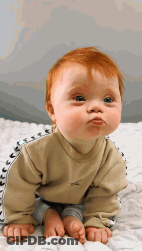 Baby With Red Hair Making Funny Face GIF