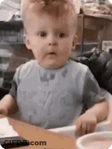 Baby With Spoon In Mouth Making Funny Face GIF