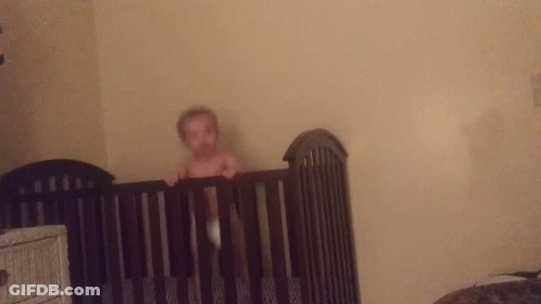 Baby Without Shirt In Black Crib GIF
