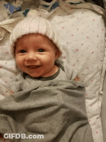 Baby Wrapped In Blanket Wearing Hat GIF