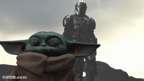 Baby Yoda In Front Of Armored Man Arms Crossed GIF