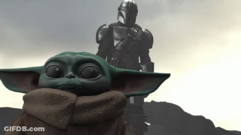 Baby Yoda Sitting In Front Of Statue GIF