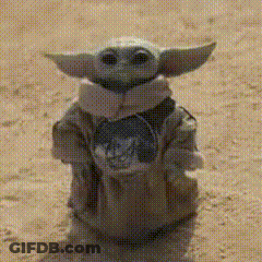 Baby Yoda Statue Standing On Sand GIF