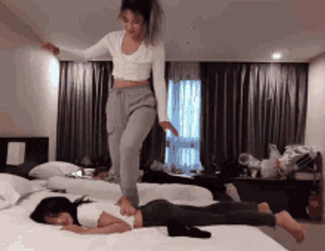 Back Massage Hotel Bed Stepping Foot Funny Girls GIF