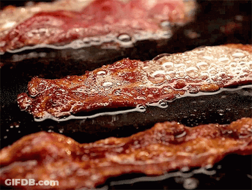 Bacon Is Being Cooked In A Frying Pan GIF
