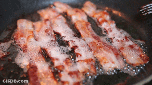 Bacon Is Being Cooked In A Frying Pan With Bubbles GIF