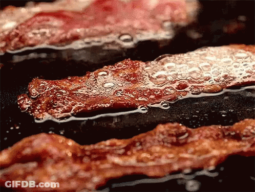 Bacon Is Being Cooked In A Frying Pan With Bubbles Coming Out Of It GIF