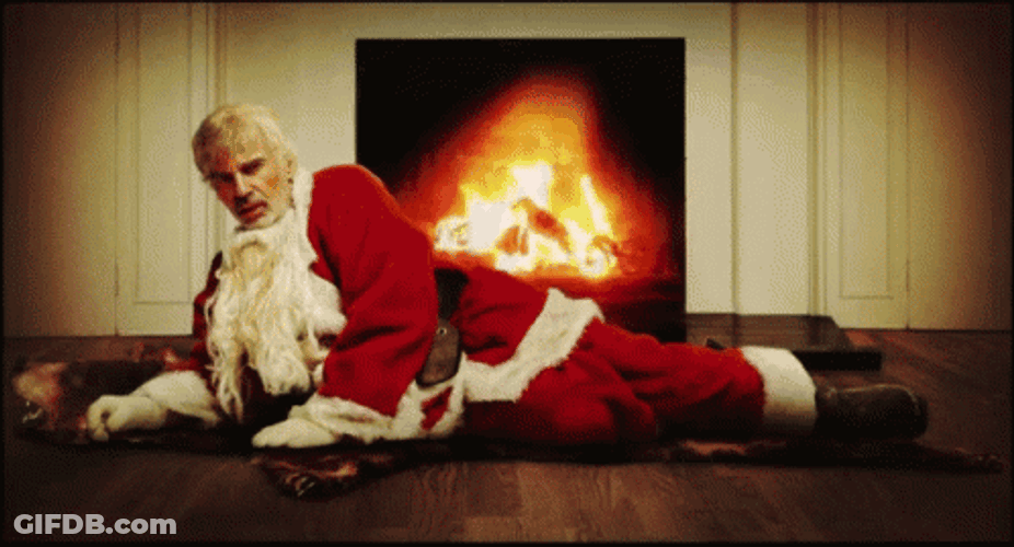 Bad Santa On The Fireplace GIF