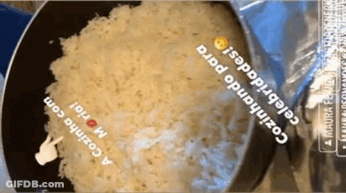 Bag Of Rice Being Cooked In Frying Pan With Hand Pointing GIF