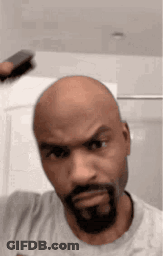 Bald Bearded Man Brushing Hair GIF