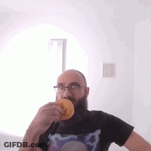 Bald Bearded Man Eating Donut GIF