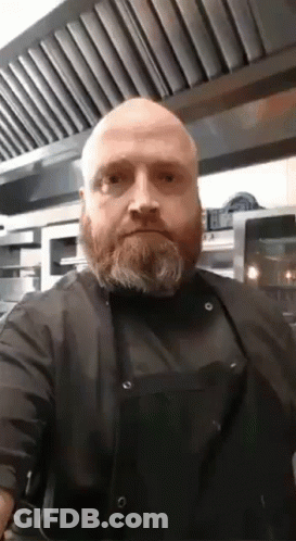 Bald Bearded Man In Black Apron And Shirt GIF