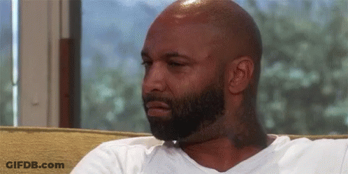 Bald Bearded Man Sitting On Couch GIF