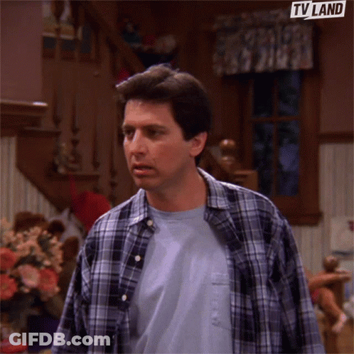 Bald Bearded Man Sitting On Couch GIF