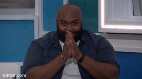 Bald Bearded Man Sitting With Folded Hands GIF