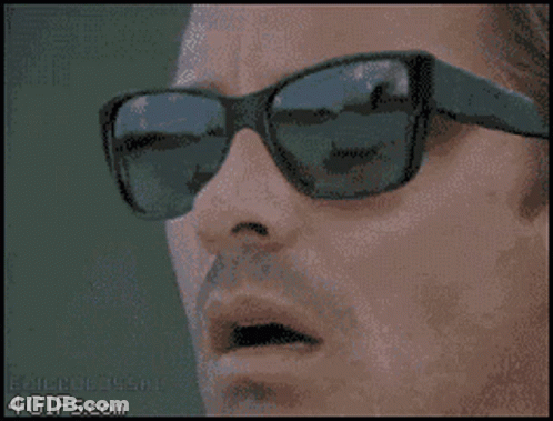 Bald Bearded Man Wearing Sunglasses And Earbuds GIF