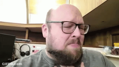 Bald Bearded Man With Glasses And Headphones GIF