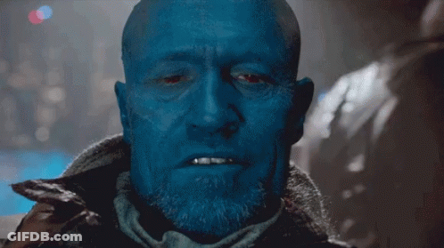 Bald Blue-Faced Man With Beard Looking At Camera GIF