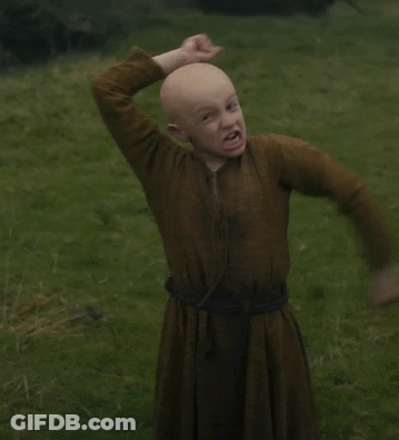 Bald Boy In Brown Dress In Grassy Field GIF