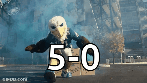 Bald Eagle Mascot Standing Next To Box With 5-0 GIF