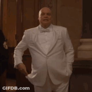 Bald Man Adjusting White Tuxedo GIF