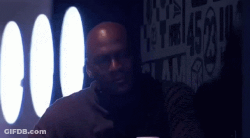 Bald Man At Table With Jordan Sign GIF