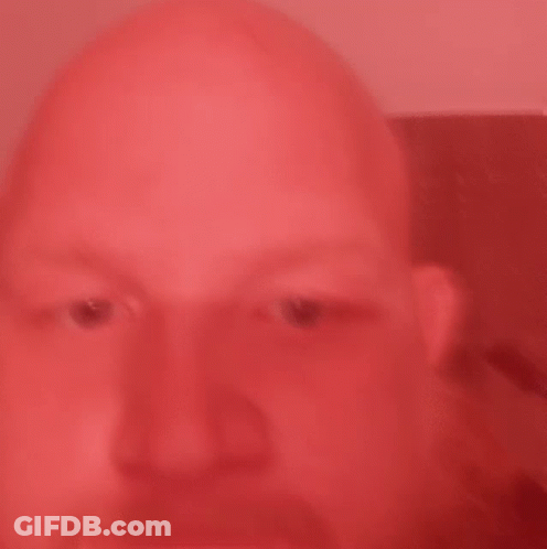Bald Man Close Up Red Background GIF
