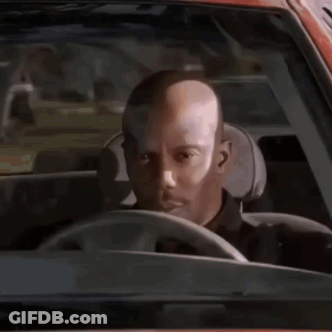 Bald Man Driving Looking At Camera GIF