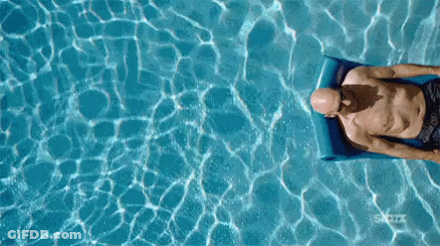Bald Man Floating On Raft In Pool GIF