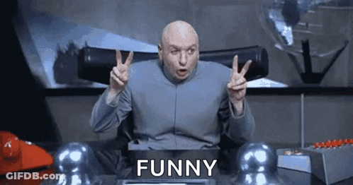 Bald Man Giving Peace Sign At Desk Saying Funny GIF