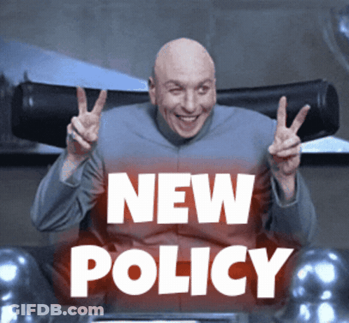 Bald Man Giving Peace Sign In Front Of New Policy Sign GIF
