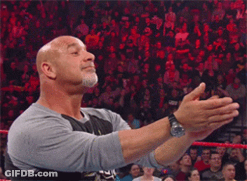 Bald Man Giving Thumbs Up In Front Of Crowd GIF