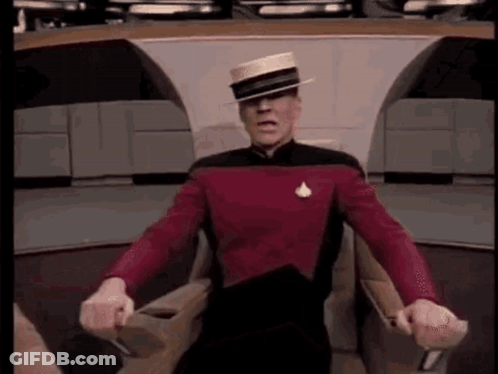 Bald Man Holding Head With Gloved Hands GIF