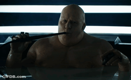 Bald Man Holding Whip In Mouth GIF