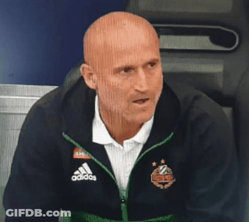 Bald Man In Adidas Jacket Sitting In Chair GIF