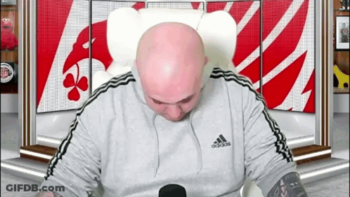 Bald Man In Adidas Shirt In Front Of Sesame Street Sign GIF