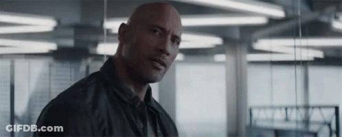 Bald Man In Black Jacket Standing Serious GIF