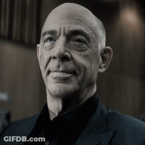 Bald Man In Black Shirt And Suit Smiling GIF
