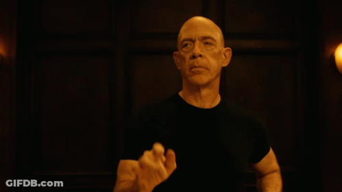 Bald Man In Black Shirt Raising Hand GIF