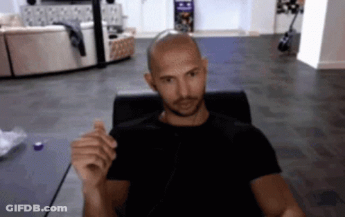 Bald Man In Black Shirt Sitting At Computer GIF